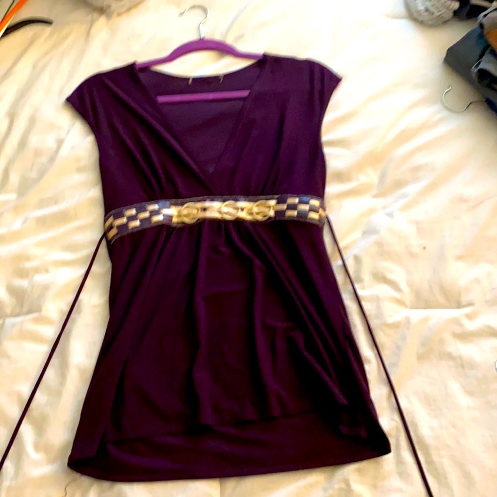 Purple top with detailing at waist.